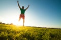 Young man jumping on meadow with dandelions Royalty Free Stock Photo