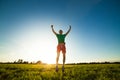 Young man jumping on meadow with dandelions Royalty Free Stock Photo