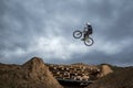 Young man jumping over hole in dirtjump circuit