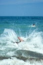 Young man jumping into sea water Royalty Free Stock Photo