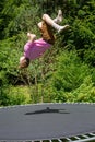 Young man jumping on a trampoline outdoors in garden Royalty Free Stock Photo