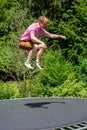 Young man jumping on a trampoline outdoors in garden Royalty Free Stock Photo