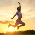 Young man jumping up against the sunset sky Royalty Free Stock Photo