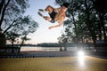 Young man jumping on the yellow trampoline Royalty Free Stock Photo