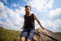 Young man jumps from the top of the rock Royalty Free Stock Photo