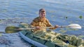 Young man in kayak. Ecotourism, visiting fragile, undisturbed natural areas. Active holidays