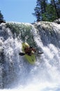 Young man kayaking down waterfall Royalty Free Stock Photo