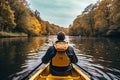 Young man kayaking on a lake in autumn. View from behind. A persons rear view of enjoying an eco friendly activity of kayaking, AI