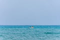 A young man kayaking in the Mediterranean sea.