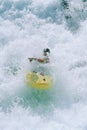 Young man kayaking in rapids