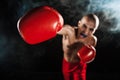 The young man kickboxing on black with kapa in mouth Royalty Free Stock Photo