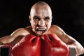 The young man kickboxing on black with kapa in mouth Royalty Free Stock Photo