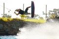 Hang loose. Young man kicks up waterspray on his wakeboard while doing a jump - copyspace. Royalty Free Stock Photo