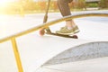 young man on kisck scooter trains to ride fast and perform tricks in skate park