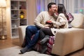 Young man kissing his wife cheek on christmas day Royalty Free Stock Photo