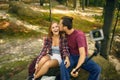 Young man kissing a young women in the forest