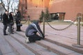 A young man knelt before the eternal flame at the grave of the Unknown soldier-a monument to all those who died in the great Patri