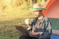 Young man laptop coffee camping tent Royalty Free Stock Photo