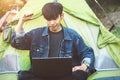 Young man laptop coffee camping tent Royalty Free Stock Photo