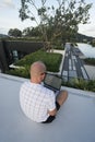 Young man with laptop computer on a rooftop Royalty Free Stock Photo