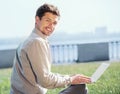 Young man with laptop outdoor portrtait Royalty Free Stock Photo