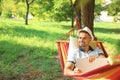 Young man with laptop resting in comfortable hammock Royalty Free Stock Photo