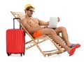 Young man with laptop and suitcase on sun lounger against white background Royalty Free Stock Photo