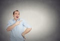 Young man, laughing, pointing with finger, arms at someone Royalty Free Stock Photo