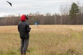 Young man launches rc plane into sky. Teenager with glasses playing with toy radio-controlled airplane outdoors. Boy Royalty Free Stock Photo