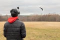 Young man launches rc plane into sky. Teenager with glasses playing with toy radio-controlled airplane outdoors. Boy Royalty Free Stock Photo