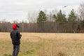 Young man launches rc plane into sky. Teenager with glasses playing with toy radio-controlled airplane outdoors. Boy Royalty Free Stock Photo