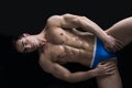 Young man laying on the floor with naked muscular body