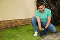 Young man laying grass sod at backyard, space for text Royalty Free Stock Photo