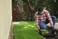 Young man laying grass sod on ground at backyard, space for text Royalty Free Stock Photo