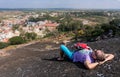 Young man is laying on a mountain and having rest