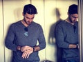 Young man leaning against mirror in elevator Royalty Free Stock Photo