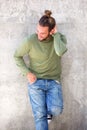 Young man leaning against wall with hand in hair Royalty Free Stock Photo