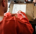 Young man learn how to write medieval font alphabet with a quill pen and inkwell