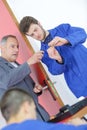 Young man learning to fixi door with screwdriver