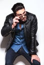 Young man in leather jacket taking off his sunglasses Royalty Free Stock Photo