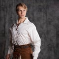 A young man in a leather kilt and a white lace-up blouse. A Scottish knight