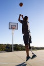 Young man with leg prosthesis throwing basketball Royalty Free Stock Photo