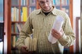 Young man in a library with books Royalty Free Stock Photo