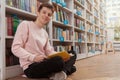 Young man at the library or bookstore Royalty Free Stock Photo