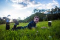 Young man lies on green grass with laptop and working Royalty Free Stock Photo