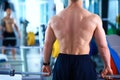 Young man lifting the barbell in gym with instructor Royalty Free Stock Photo