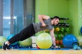 Young man lifting dumbbell at the fitness center Royalty Free Stock Photo