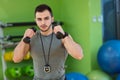 Young man lifting dumbbell at the fitness center Royalty Free Stock Photo