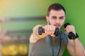 Young man lifting dumbbell at the fitness center Royalty Free Stock Photo