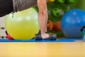 Young man lifting dumbbell at the fitness center Royalty Free Stock Photo